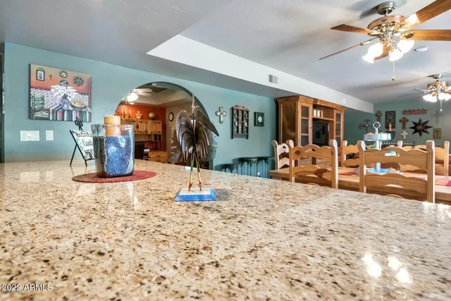 a view of a livingroom with kitchen and furniture