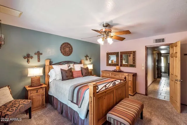 a bedroom with bed and a chandelier