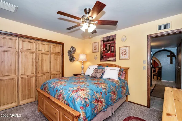 a bedroom with a bed and a chandelier