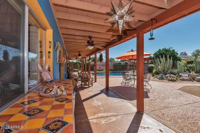 a view of a patio with a table and chairs