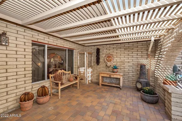 a balcony with furniture and potted plants
