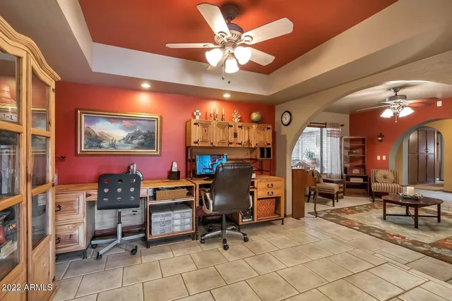 a view of a livingroom with workspace and a window