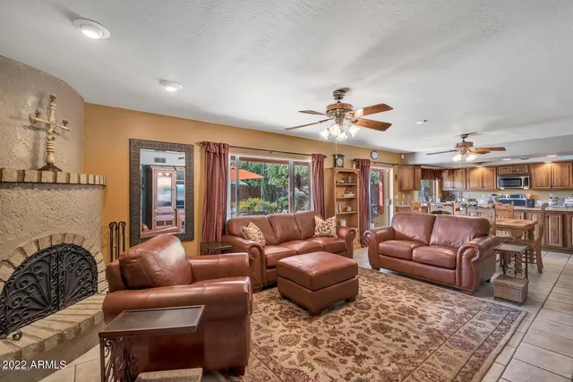 a living room with furniture ceiling fan and a rug