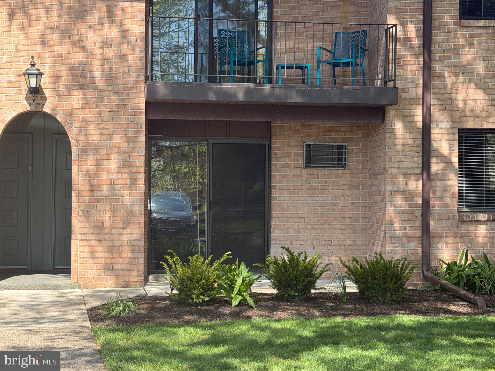 Charming brick facade with greenery.