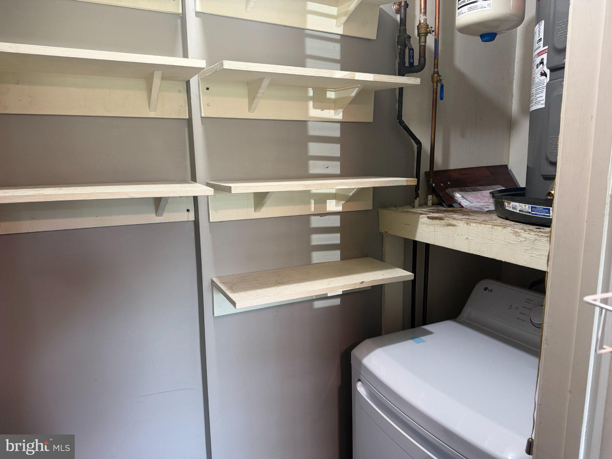 612 North Shady Retreat Road, Unit 11 Doylestown, PA 18901 - Photo 7 of 9 Efficient laundry space with shelving.