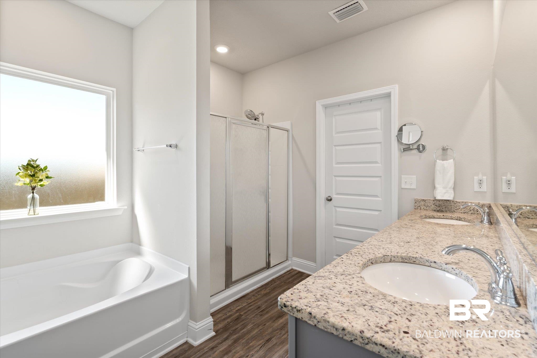 12899 Sanderling Loop Daphne, AL 36527 - Photo 16 of 28 Bathroom featuring vanity, hardwood / wood-style floors, and plus walk in shower
