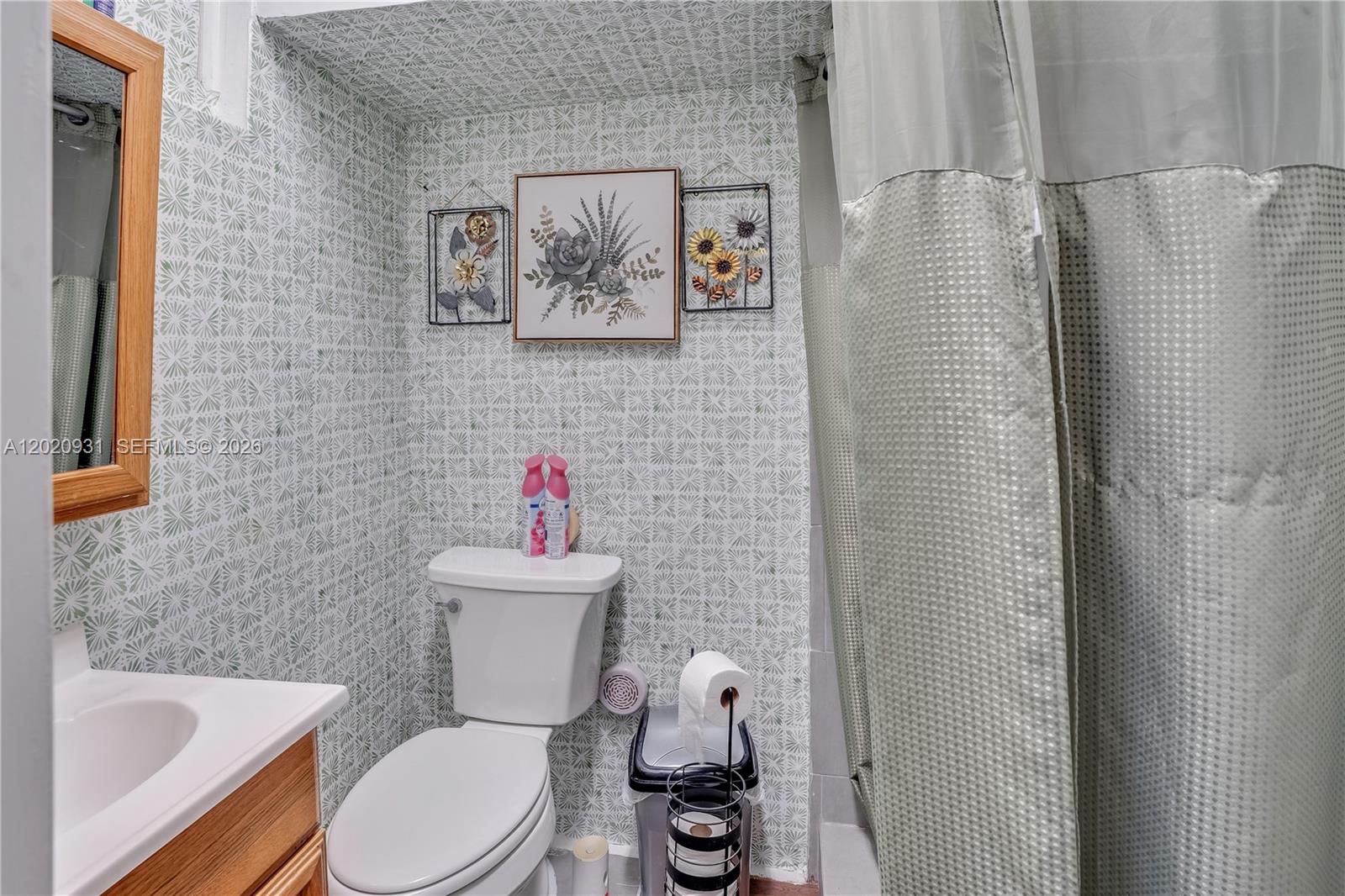 1360 Northwest 77th Street Miami, FL 33147 - Photo 26 of 41 a white toilet sitting next to a bathroom sink