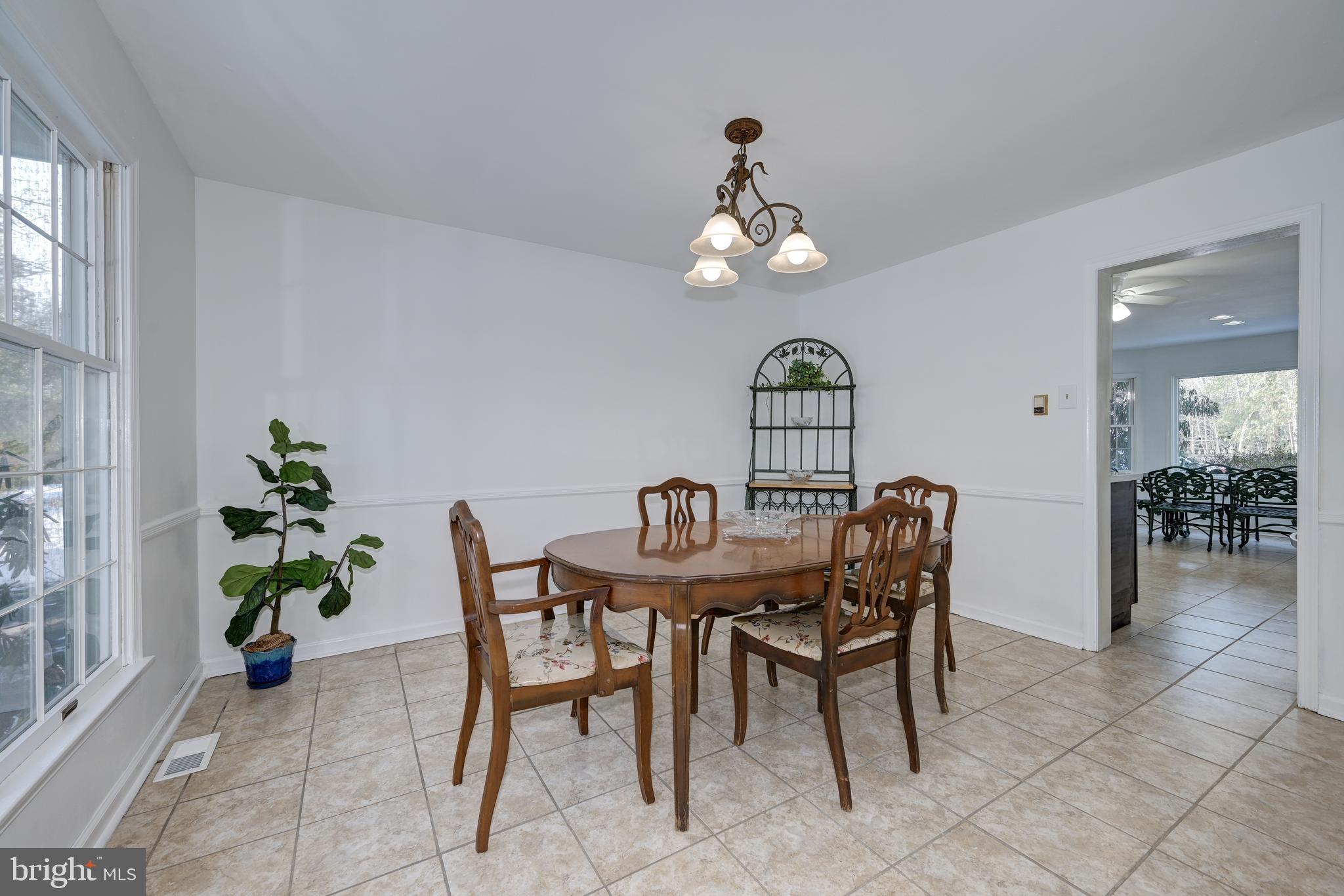 12 Friar Tuck Drive Medford, NJ 08055 - Photo 16 of 68 a view of a dining room with furniture wooden floor and a chandelier