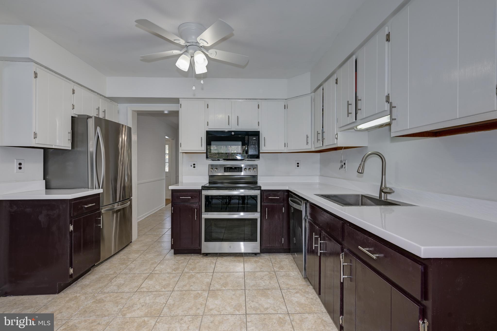 12 Friar Tuck Drive Medford, NJ 08055 - Photo 21 of 68 a kitchen with stainless steel appliances granite countertop a sink stove and refrigerator