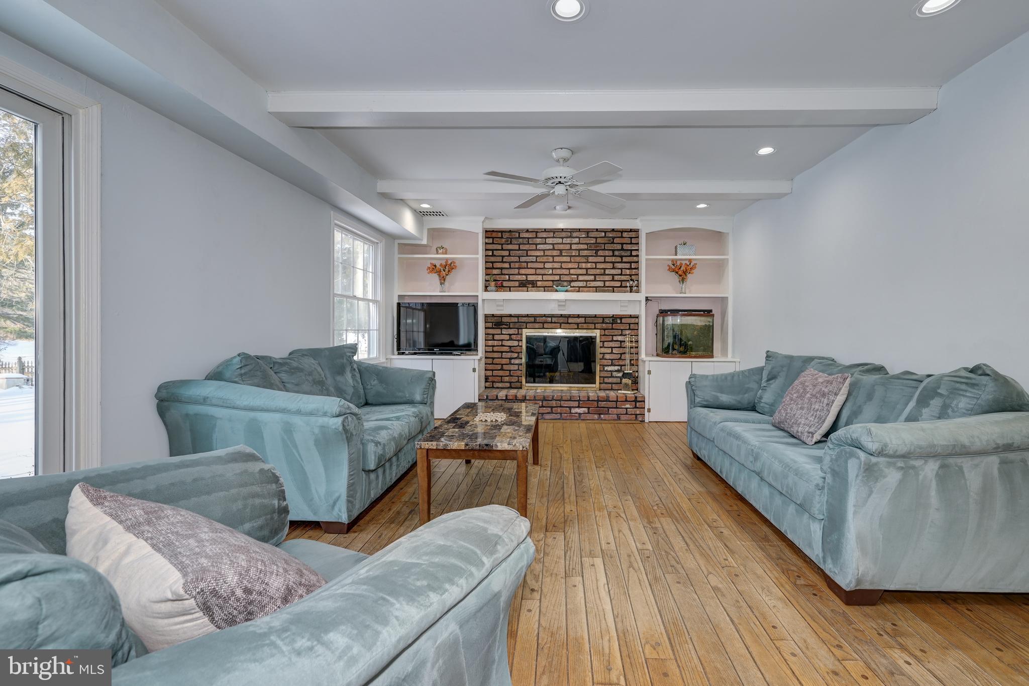 12 Friar Tuck Drive Medford, NJ 08055 - Photo 29 of 68 a living room with furniture and a fireplace