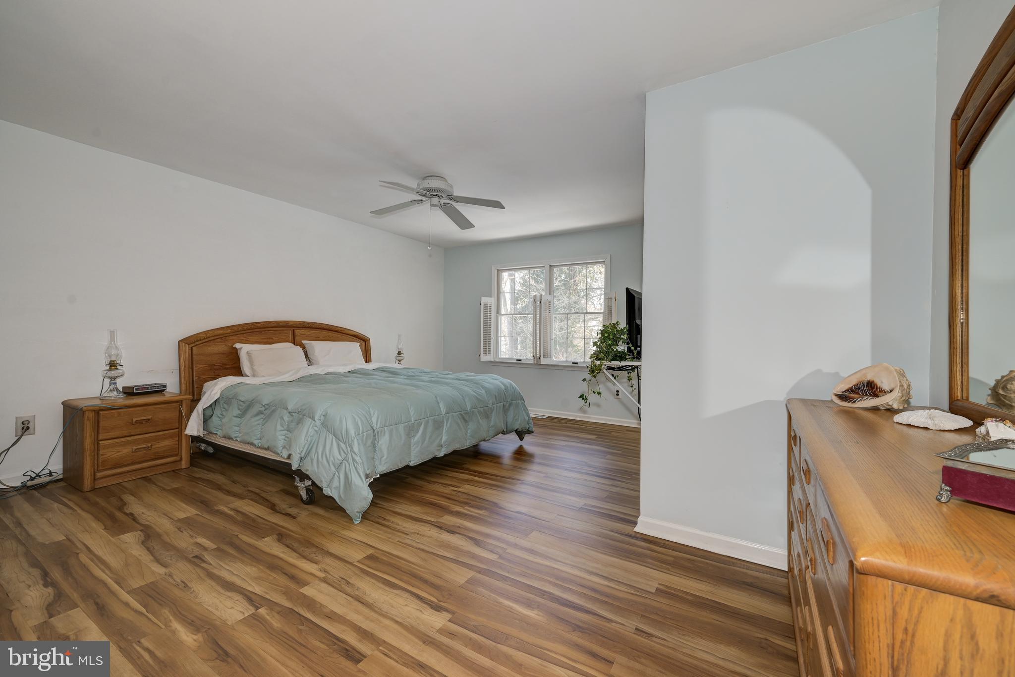 12 Friar Tuck Drive Medford, NJ 08055 - Photo 34 of 68 a bedroom with a bed and wooden floor
