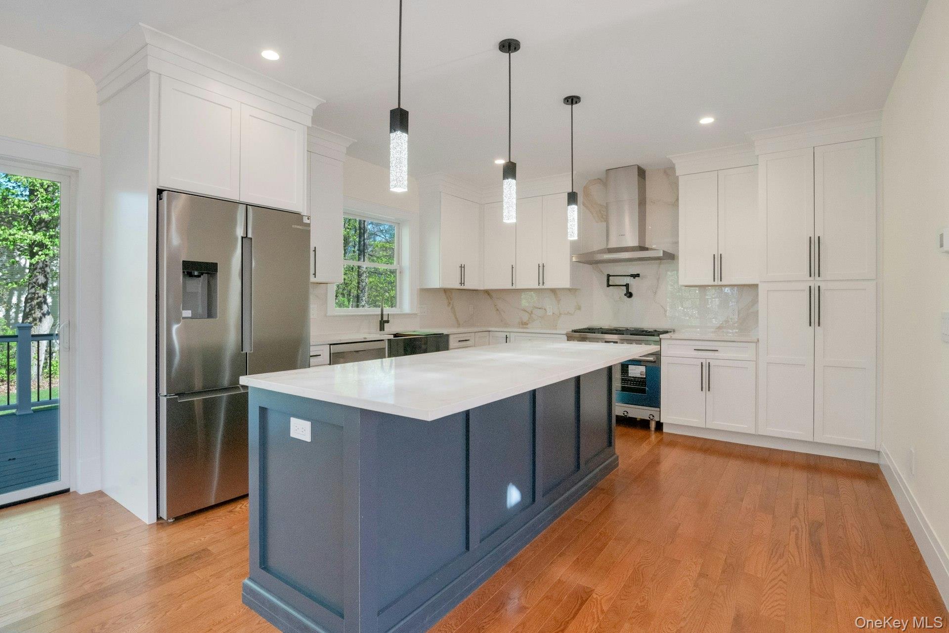 57 Meadow Sweet Road Cortlandt Manor, NY 10567 - Photo 13 of 49 Kitchen featuring center island, quartzite countertops and Bosch stainless steel appliances.