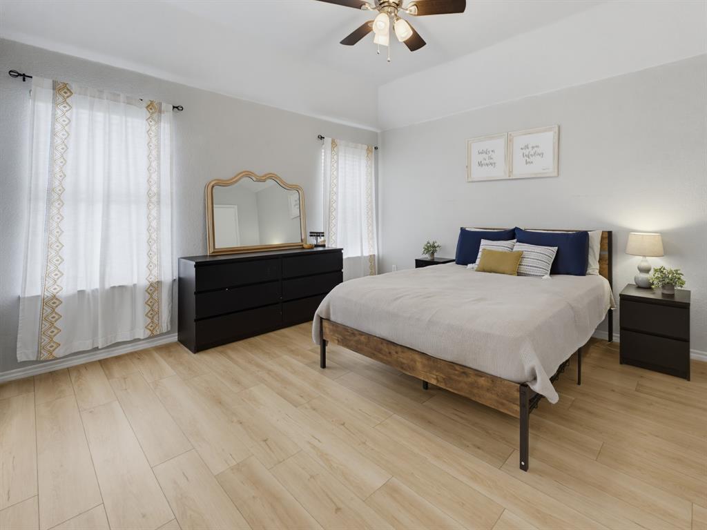 600 Stirling Road Rhome, TX 76078 - Photo 23 of 38 Spacious room featuring light wood-finish flooring, a tray ceiling, and a ceiling fan