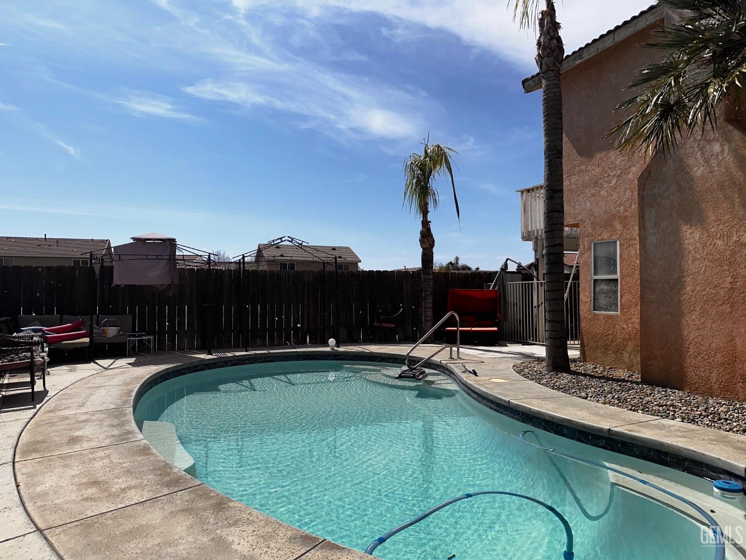 Undisclosed Address Bakersfield, CA 93313 - Photo 11 of 32 a view of a swimming pool with a yard