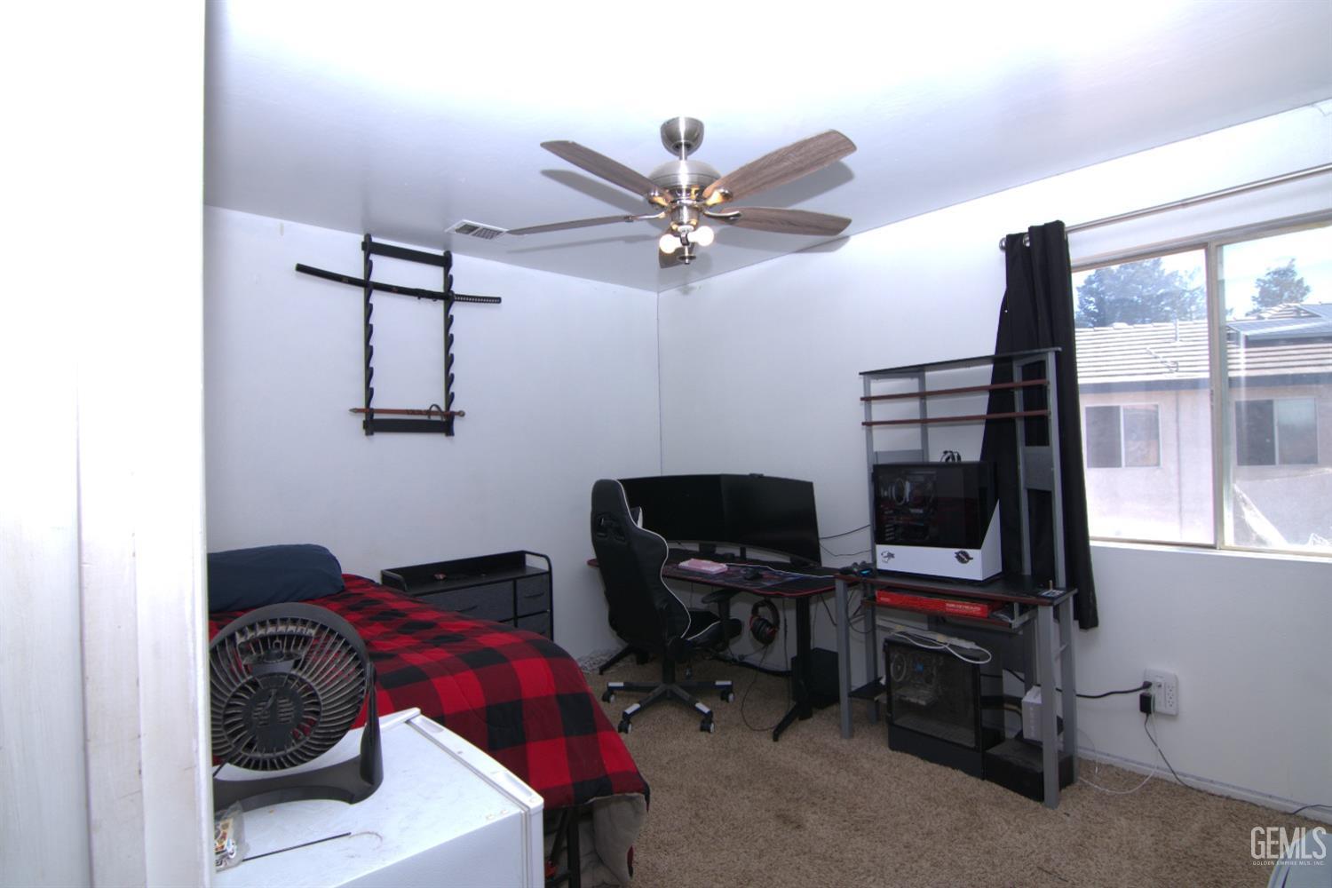 Undisclosed Address Bakersfield, CA 93313 - Photo 15 of 32 a bedroom with a bed and a window