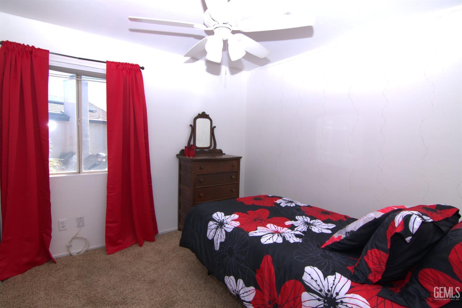 Undisclosed Address Bakersfield, CA 93313 - Photo 16 of 32 a bedroom with a bed and a chandelier