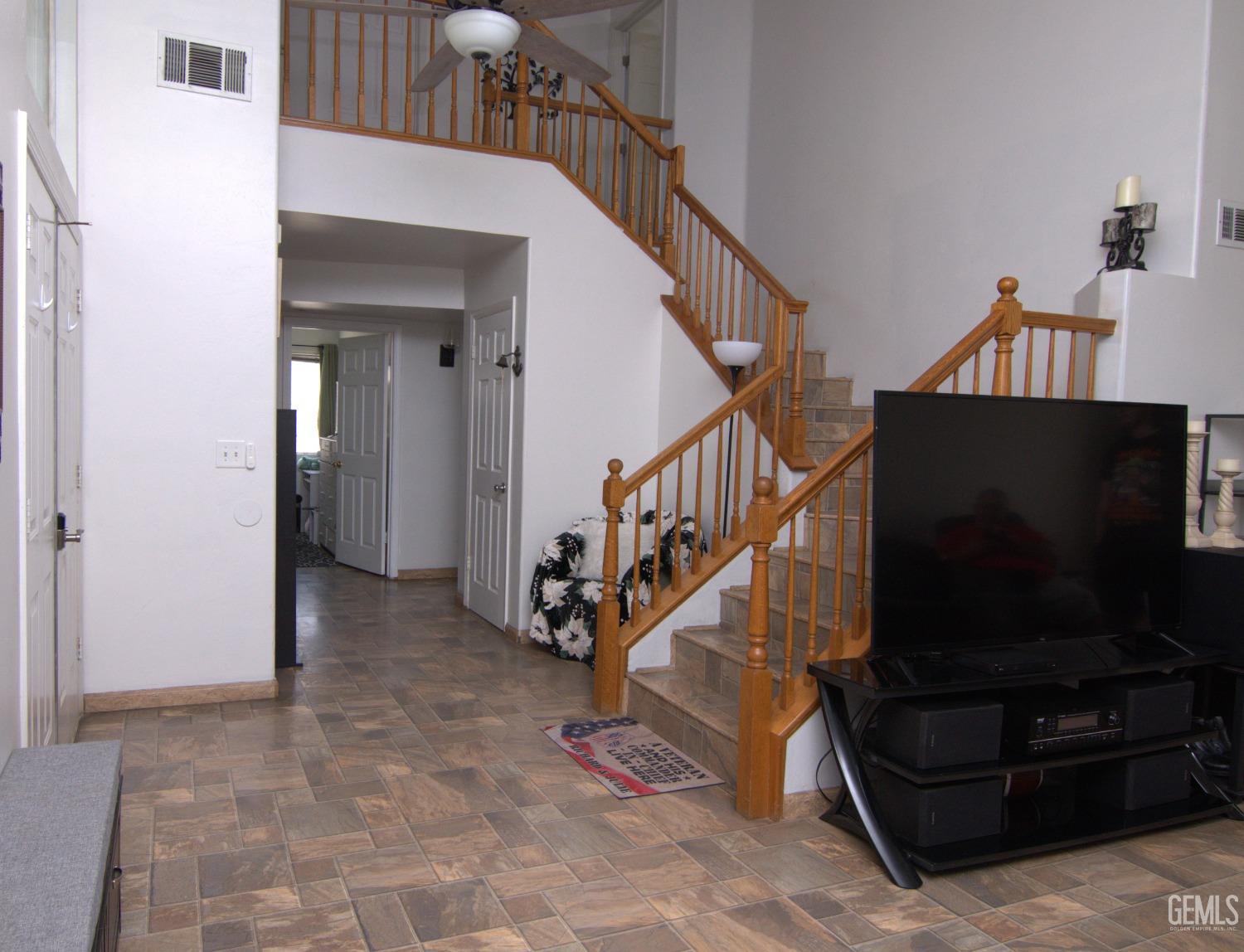 Undisclosed Address Bakersfield, CA 93313 - Photo 23 of 32 a living room with furniture and a flat screen tv