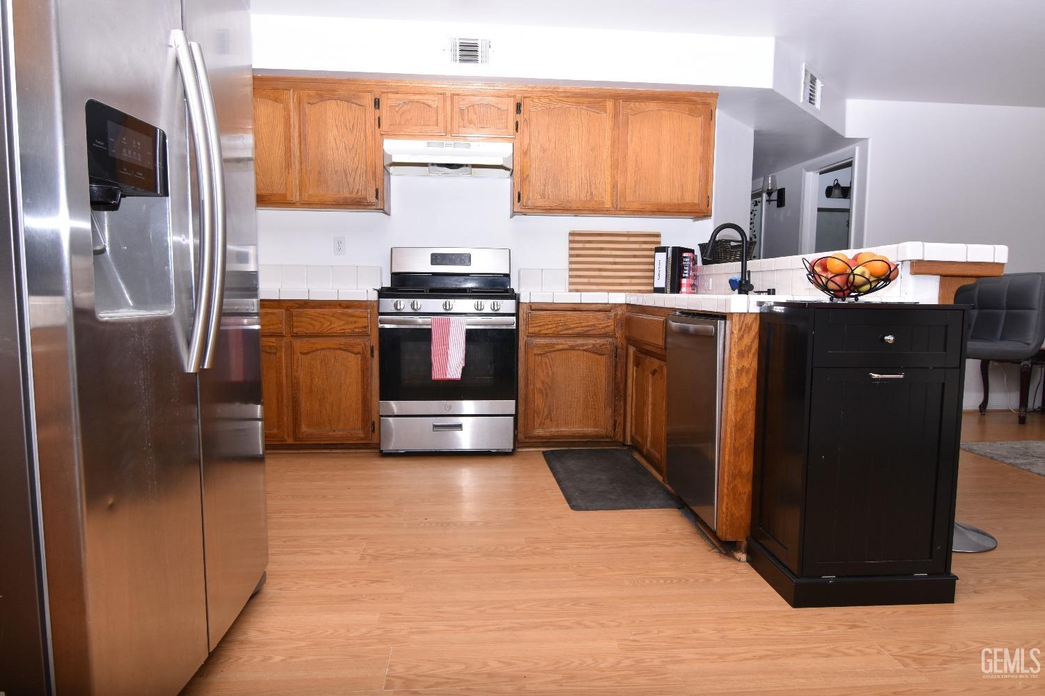 Undisclosed Address Bakersfield, CA 93313 - Photo 29 of 32 a kitchen with stainless steel appliances a refrigerator stove and sink