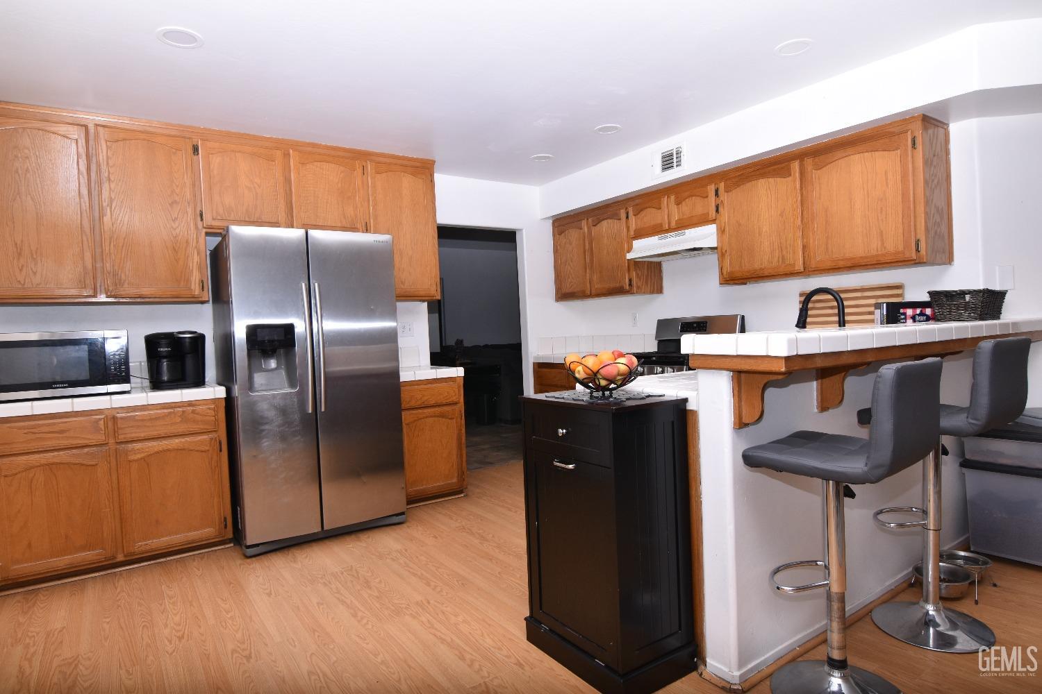 Undisclosed Address Bakersfield, CA 93313 - Photo 30 of 32 a kitchen with stainless steel appliances granite countertop a refrigerator a sink a stove and a refrigerator