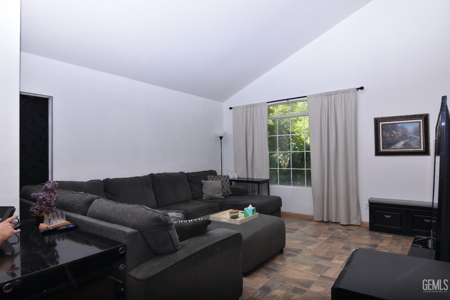 Undisclosed Address Bakersfield, CA 93313 - Photo 32 of 32 a living room with furniture and a window