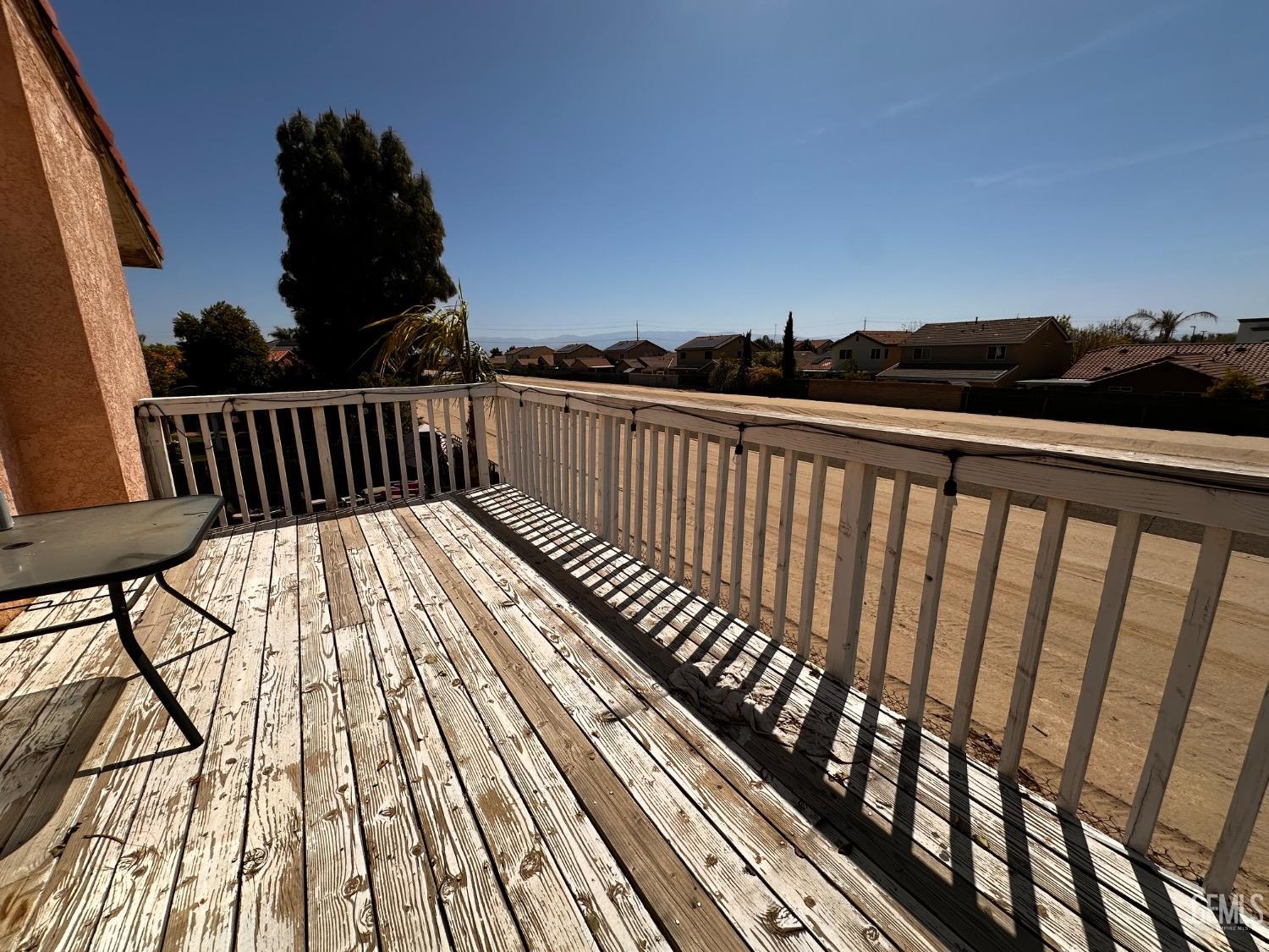 Undisclosed Address Bakersfield, CA 93313 - Photo 5 of 32 a view of balcony with wooden floor and fence