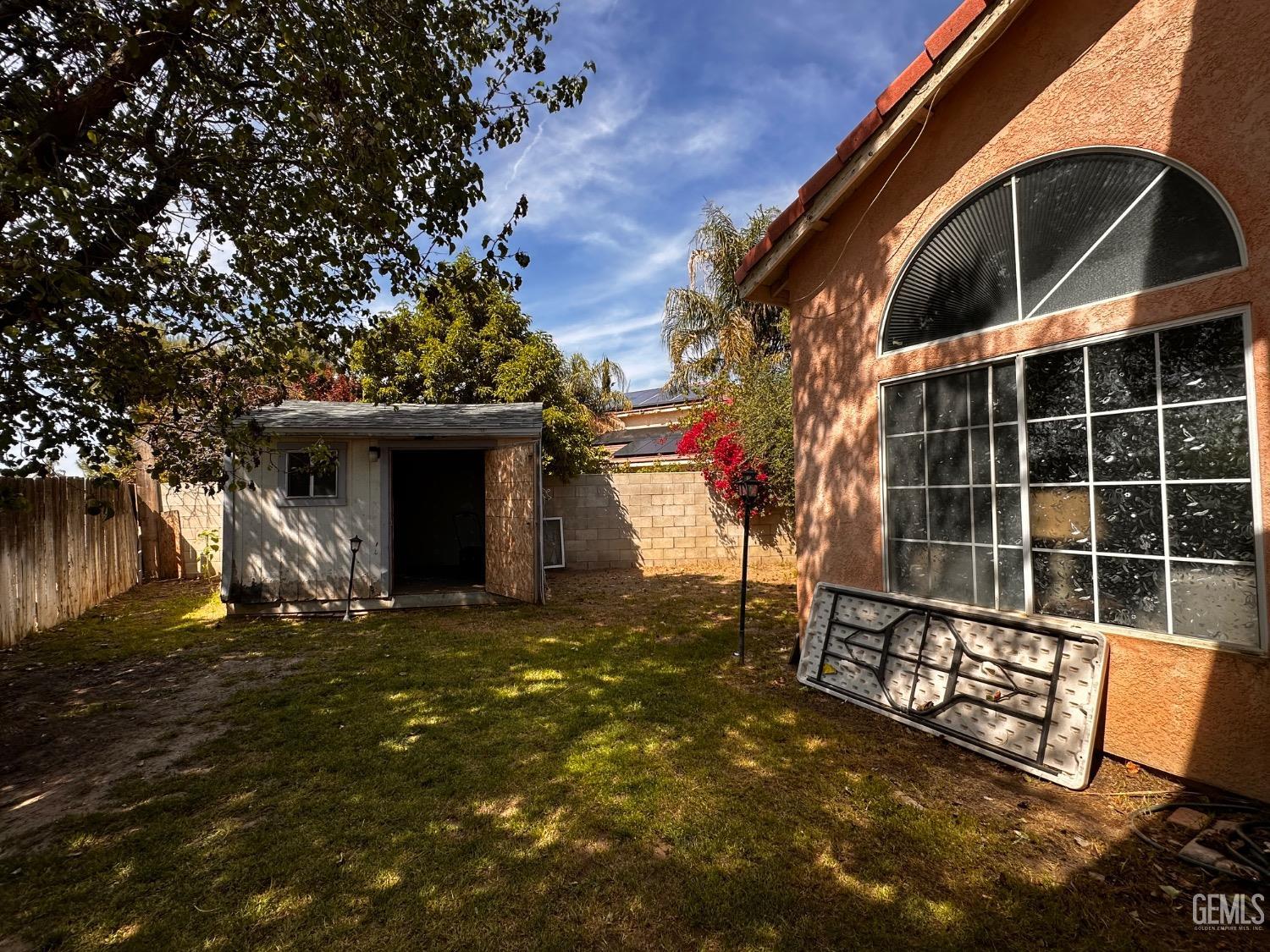 Undisclosed Address Bakersfield, CA 93313 - Photo 7 of 32 a view of a house with a large tree
