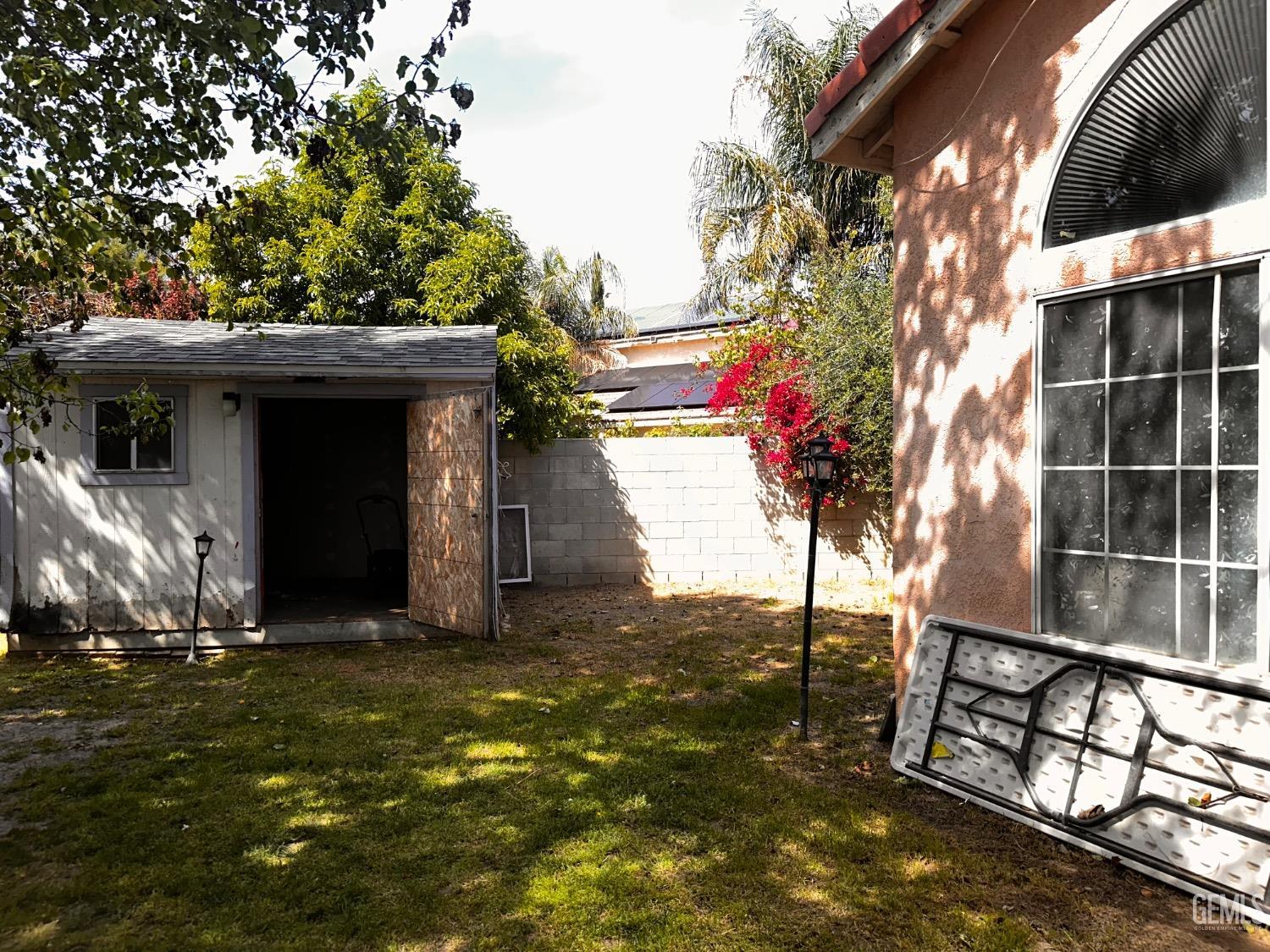 Undisclosed Address Bakersfield, CA 93313 - Photo 9 of 32 a view of a house with a tree