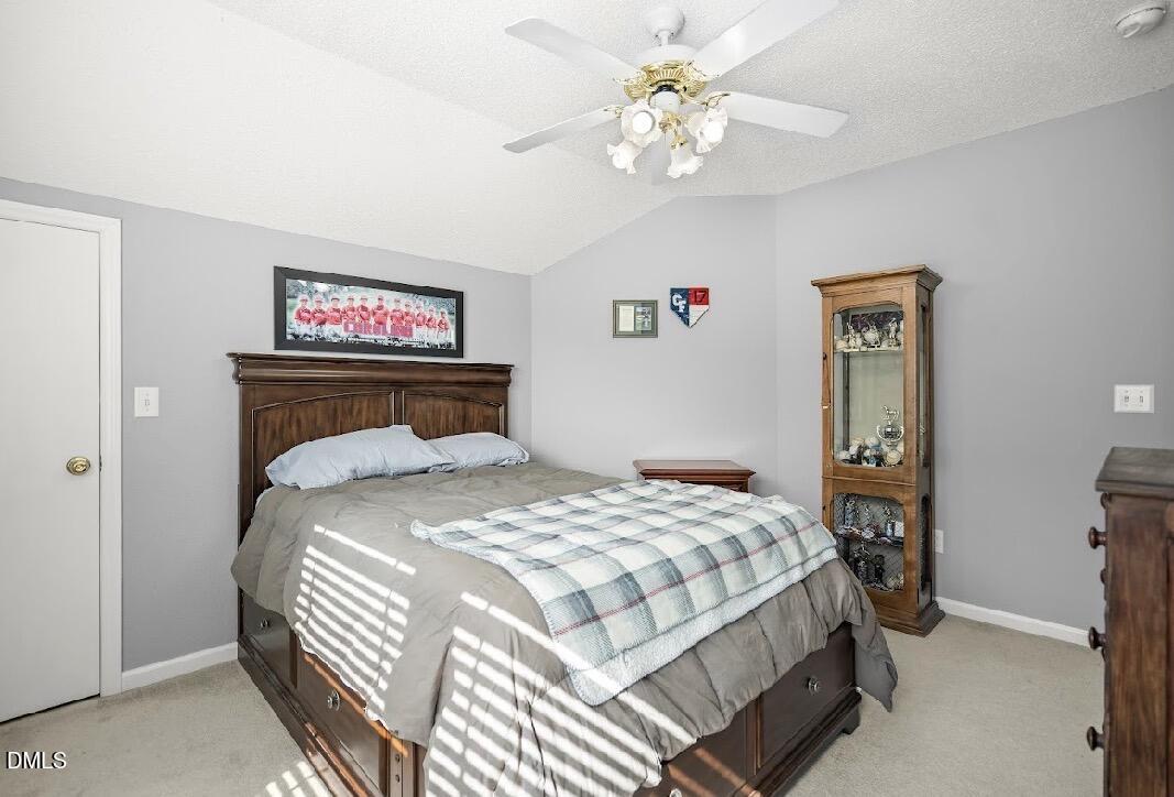 5780 McArthur Road Broadway, NC 27505 - Photo 28 of 40 a bedroom with a bed and a chandelier