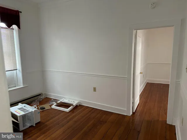 a room with wooden floor and gym equipment