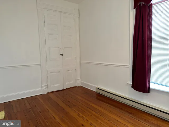 a view of a room with wooden floor