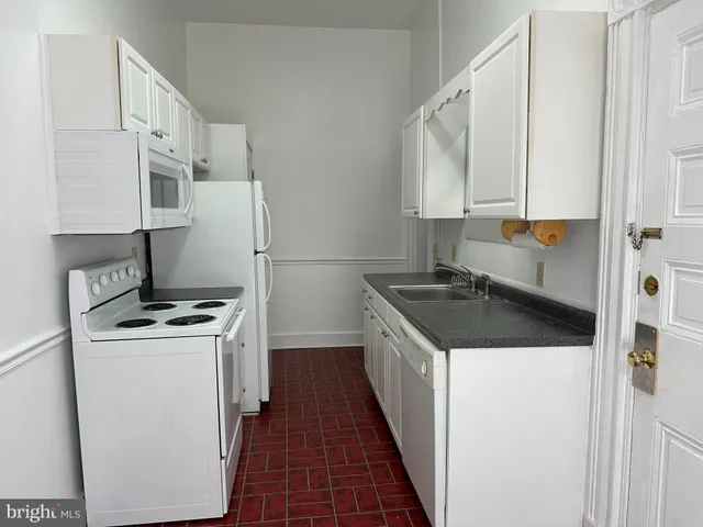 a kitchen with a stove and a refrigerator