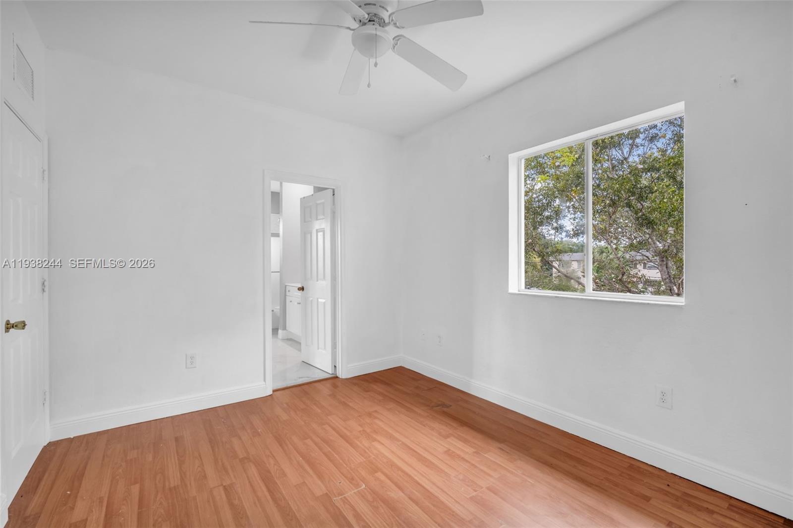 400 Princess Drive Margate, FL 33068 - Photo 12 of 26 wooden floor in an empty room with a window