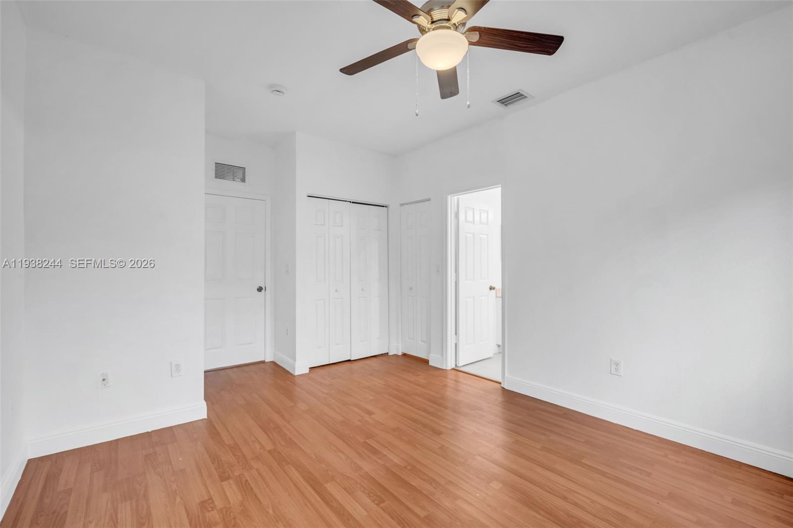 400 Princess Drive Margate, FL 33068 - Photo 13 of 26 an empty room with wooden floor and a ceiling fan