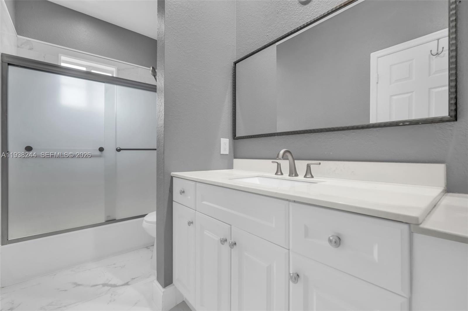 400 Princess Drive Margate, FL 33068 - Photo 14 of 26 a bathroom with a sink and a mirror