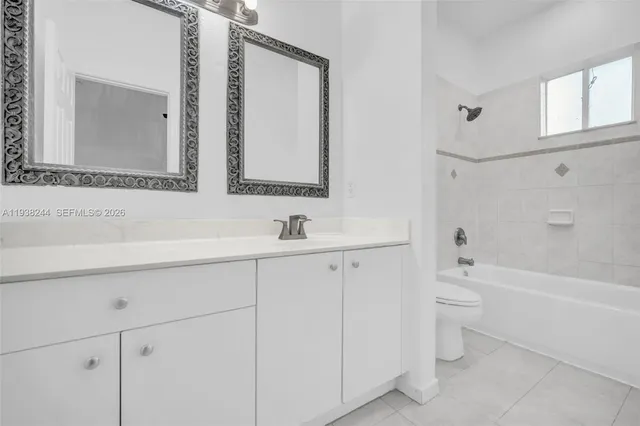 a bathroom with a bathtub shower sink and a toilet
