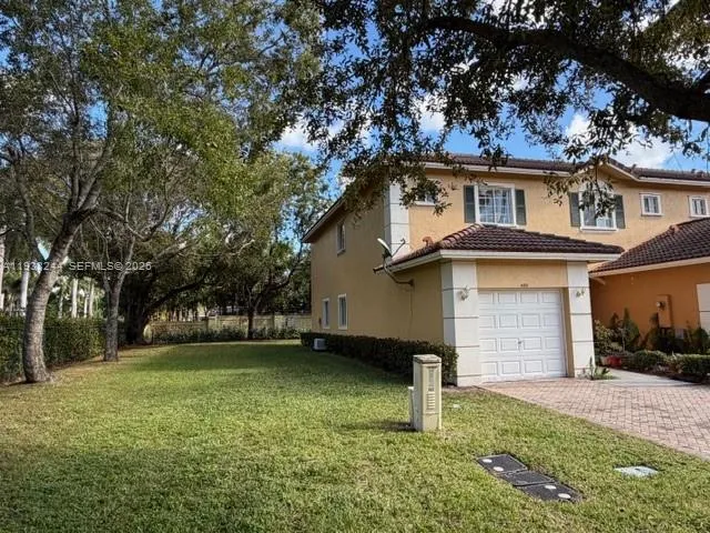 a house that has a tree in front of the house
