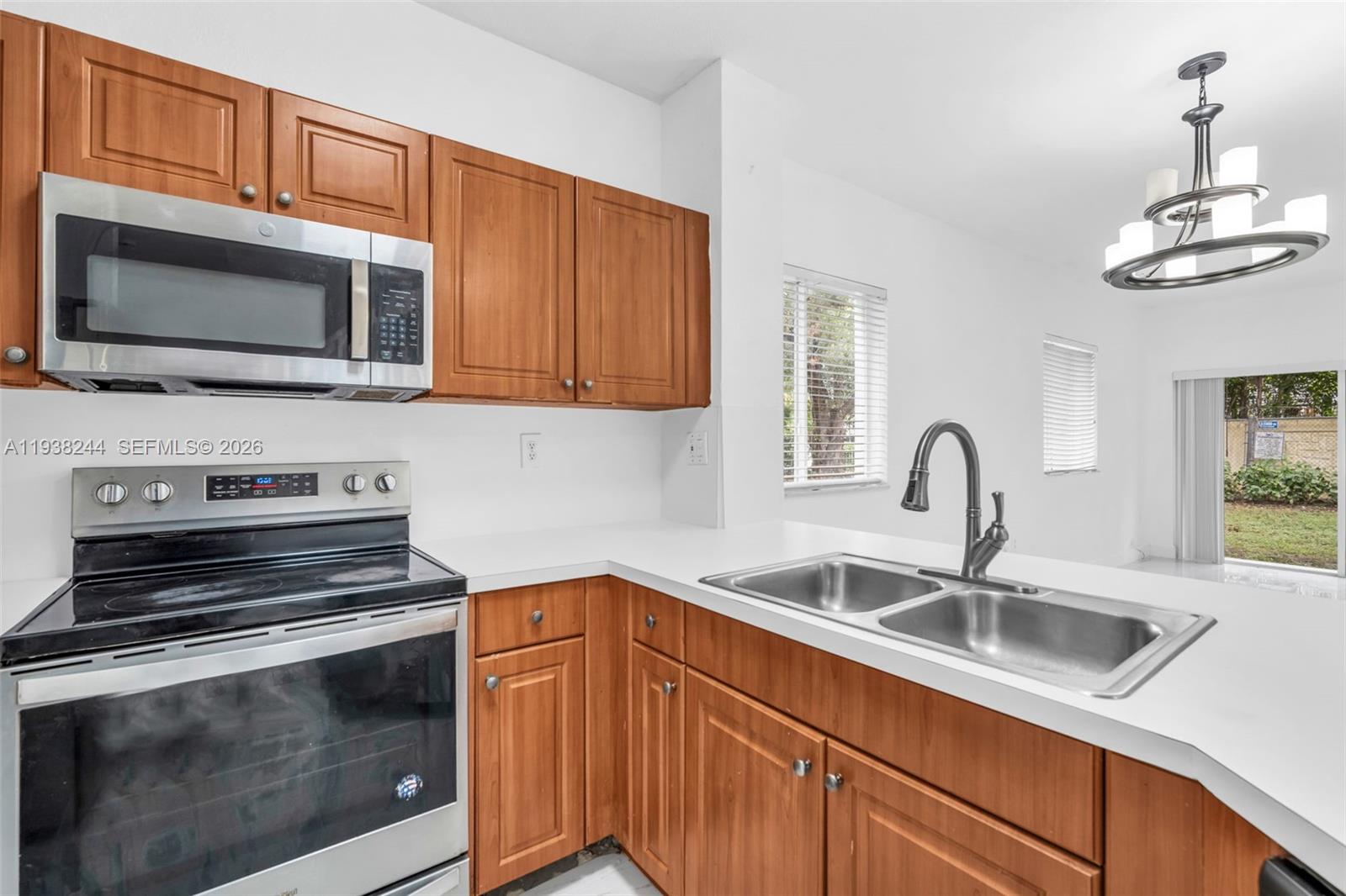 400 Princess Drive Margate, FL 33068 - Photo 5 of 26 a kitchen with stainless steel appliances a stove microwave and sink