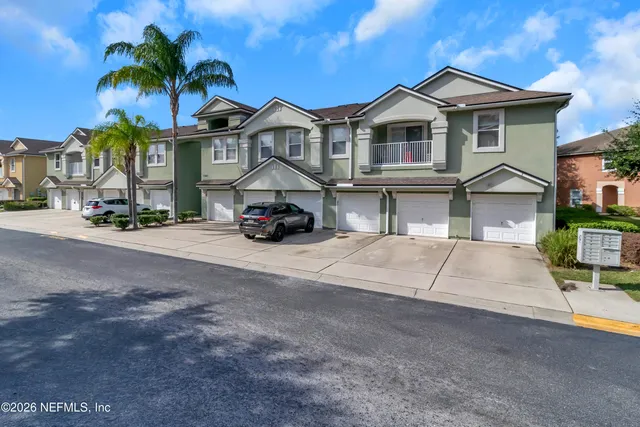 a car parked in front of a white house