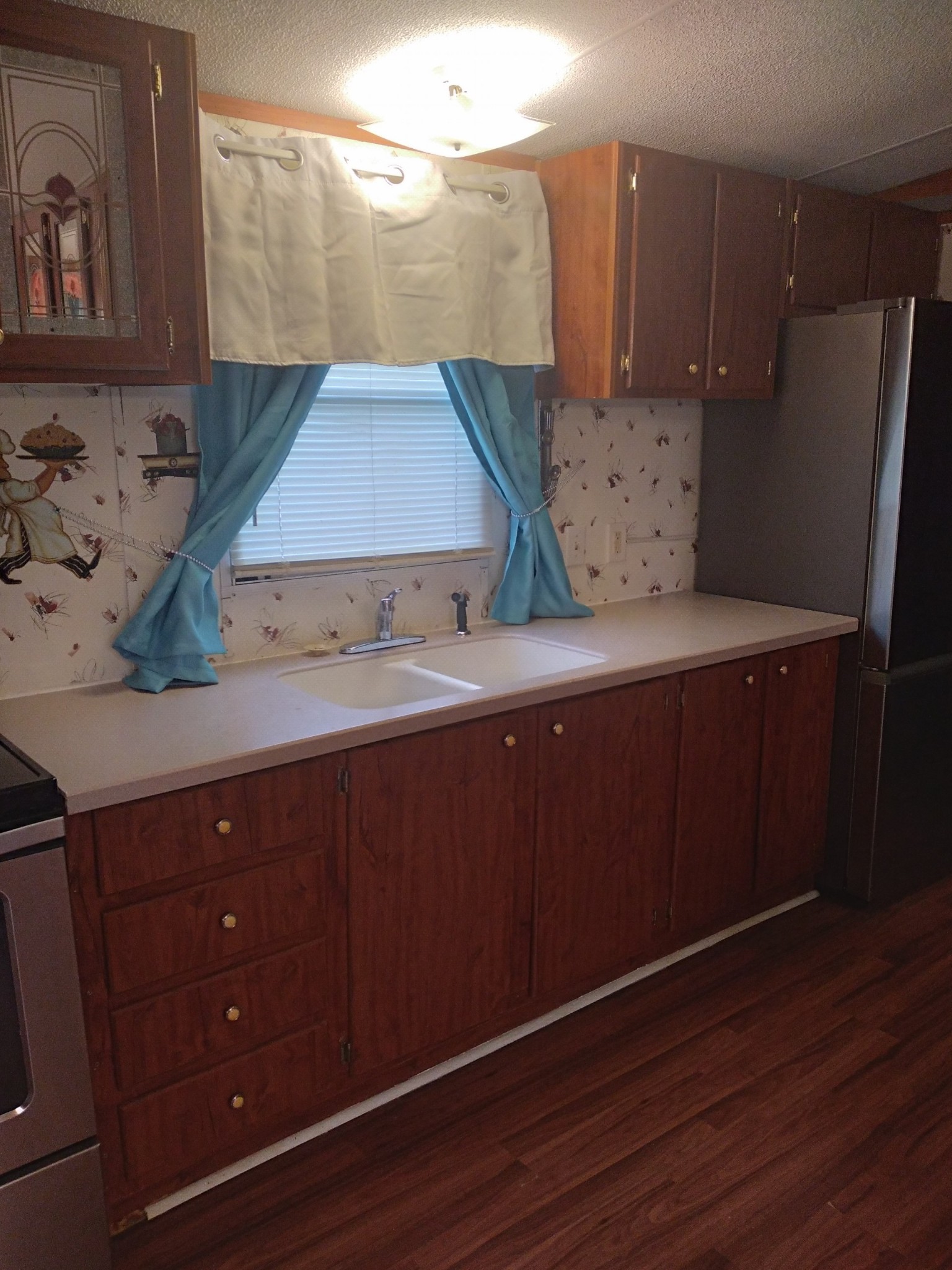 911 Ragsdale Lane Pulaski, TN 38478 - Photo 20 of 66 a kitchen with a wooden floor and cabinets