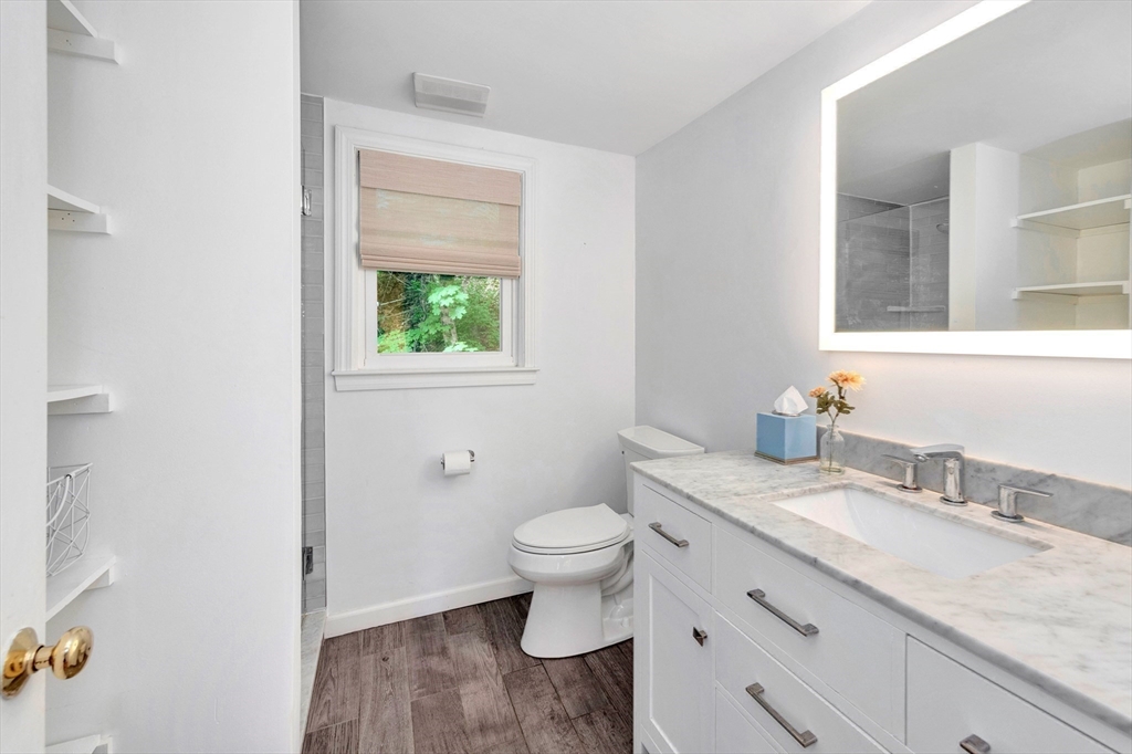 118 Woolford Road Wrentham, MA 02093 - Photo 29 of 41 a bathroom with a granite countertop toilet a sink and a mirror