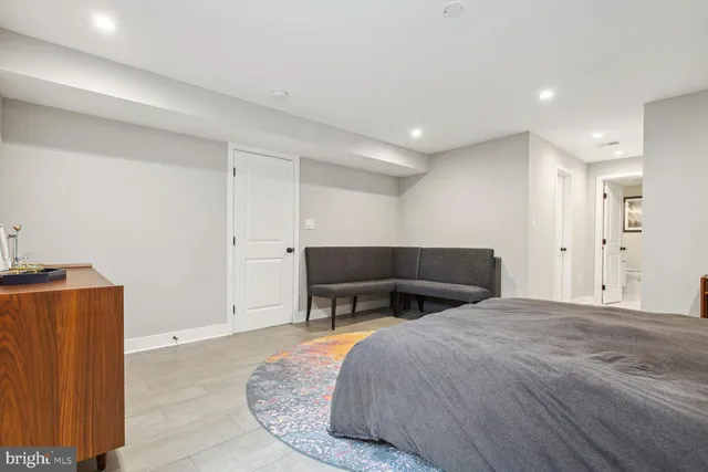 a spacious bedroom with a bed and a table