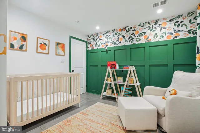 a view of a room with furniture and a flat screen tv