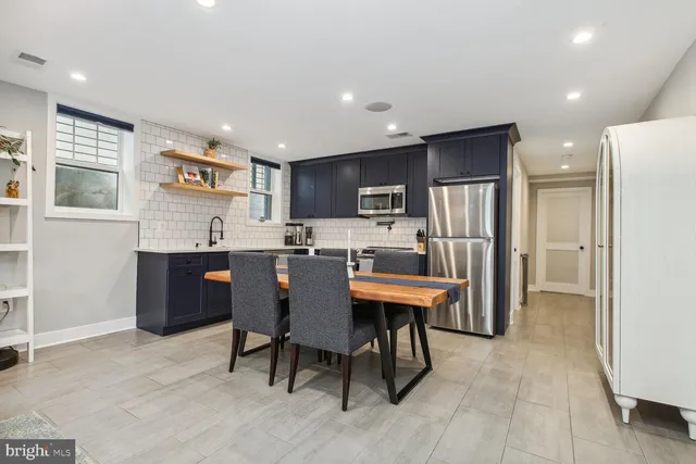 a large kitchen with a table and chairs