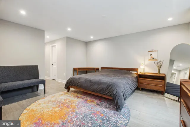 a bed room with a bed and a chair