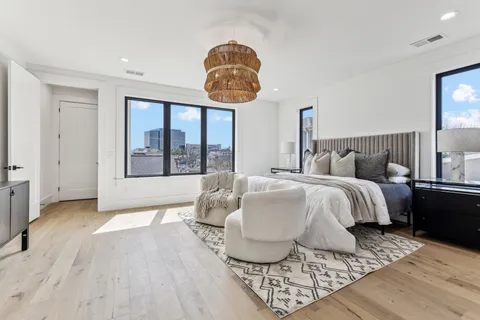 a bedroom with a bed and a chandelier