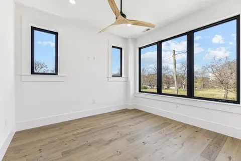 a view of an empty room with wooden floor