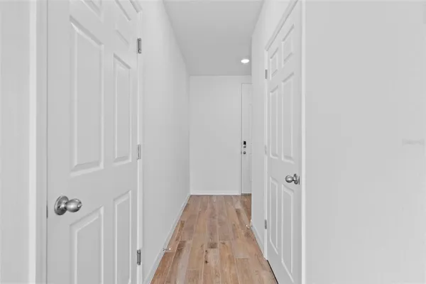 a view of a room with wooden floor