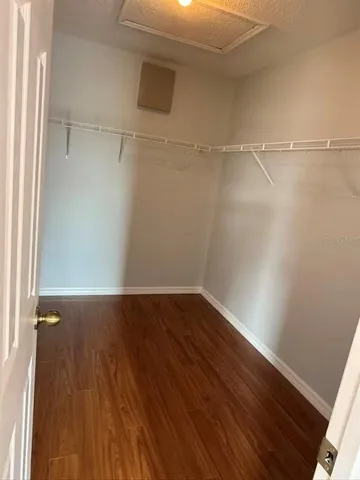 a view of a room with wooden floor