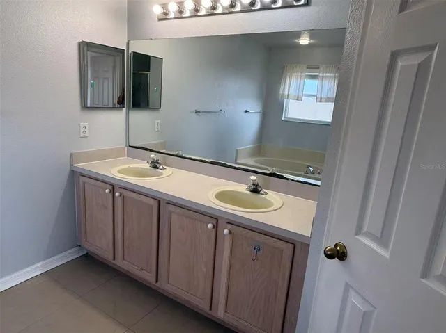 a bathroom with a sink and mirror