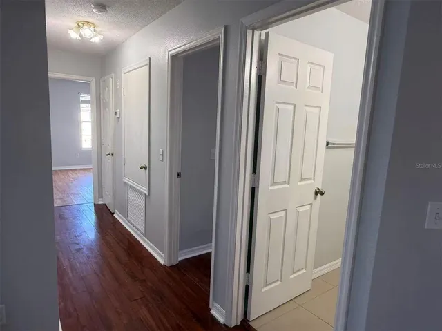 a view of a hallway with wooden floor
